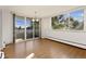 Bright dining room featuring hardwood floors and sliding glass doors to a balcony with city views at 740 N Pearl St # 203, Denver, CO 80203
