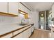 Functional kitchen featuring white cabinetry, stainless steel sink, and dishwasher at 740 N Pearl St # 203, Denver, CO 80203