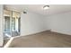 Expansive living room featuring plush carpeting, natural light, and sliding glass door access to the balcony at 740 N Pearl St # 203, Denver, CO 80203