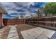 Fenced backyard featuring stepping stones, mulch, and string lights at 1906 S Vrain St, Denver, CO 80219