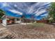 Backyard with a covered patio and a wooden fence. Plenty of yard space for recreation and relaxation at 1906 S Vrain St, Denver, CO 80219