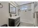 Bathroom with a black vanity, a white shower, and classic subway tiling at 1906 S Vrain St, Denver, CO 80219