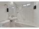 All white bathroom with a tub, sink, toilet, and mirror at 1906 S Vrain St, Denver, CO 80219