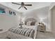 Bedroom with neutral colored walls, carpet, a ceiling fan and a well-decorated bed at 1906 S Vrain St, Denver, CO 80219