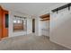 Spacious carpeted bedroom features a built in desk, mirror and closet at 1906 S Vrain St, Denver, CO 80219