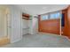 Carpeted bedroom with natural light and a closet with built in desk and shelving at 1906 S Vrain St, Denver, CO 80219