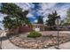 Charming brick home with a yellow front door, set back from the street with mature trees and landscaping at 1906 S Vrain St, Denver, CO 80219