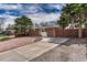 A one-story brick home featuring a spacious driveway with tasteful rock landscaping and mature trees at 1906 S Vrain St, Denver, CO 80219