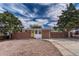 Street view of a brick ranch-style house with a sunny yellow door and neat, low-maintenance landscaping at 1906 S Vrain St, Denver, CO 80219