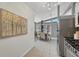 Kitchen dining area with stainless appliances, modern lighting, open shelves, and neutral decor at 1906 S Vrain St, Denver, CO 80219