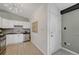 Bright kitchen features stainless steel appliances, white cabinets, tile backsplash and floors at 1906 S Vrain St, Denver, CO 80219