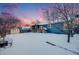 Snowy backyard with a shed, deck, and playhouse at 5557 W 75Th Pl, Arvada, CO 80003