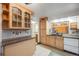 Kitchen features ample cabinetry, granite countertops, and a window overlooking backyard at 5557 W 75Th Pl, Arvada, CO 80003