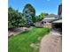 Expansive backyard boasting a lush lawn, established trees, patio, and playful trampoline; perfect for recreation and entertaining at 16639 E Berry Ln, Centennial, CO 80015