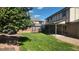 Expansive backyard with lush green lawn, privacy fence, and a covered patio for outdoor relaxation and entertainment at 16639 E Berry Ln, Centennial, CO 80015