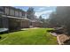 Spacious backyard features a lush green lawn, trampoline, and a covered patio, ideal for outdoor enjoyment and entertaining at 16639 E Berry Ln, Centennial, CO 80015