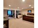 Spacious basement area with three beds, game table and natural light from a window, perfect for recreation and relaxation at 16639 E Berry Ln, Centennial, CO 80015