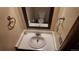 Powder room featuring a sink and a mirror that provides a view of the toilet at 16639 E Berry Ln, Centennial, CO 80015