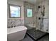 Bathroom with a free-standing tub and frameless glass shower featuring marble tile at 16639 E Berry Ln, Centennial, CO 80015