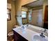 Neutral bathroom featuring a double sink vanity, framed mirror, and shower-tub combination with a patterned curtain at 16639 E Berry Ln, Centennial, CO 80015