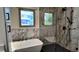 Stylish bathroom with marble-tiled walls, sleek fixtures, and a modern freestanding tub at 16639 E Berry Ln, Centennial, CO 80015