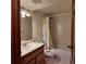 Traditional bathroom featuring neutral tiling, wood vanity, modern lighting, and a shower-tub combination with printed curtain at 16639 E Berry Ln, Centennial, CO 80015