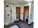 Bathroom featuring frameless glass shower with marble tile and a separate toilet area at 16639 E Berry Ln, Centennial, CO 80015
