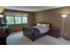 A traditionally-styled bedroom features neutral carpeting and light-filtering blinds for a serene and relaxing retreat at 16639 E Berry Ln, Centennial, CO 80015