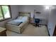Comfortable bedroom with a bed, desk and chair set, and ample natural light from the window at 16639 E Berry Ln, Centennial, CO 80015