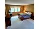 Carpeted bedroom with a sleigh bed, two nightstands, dresser, and a window at 16639 E Berry Ln, Centennial, CO 80015
