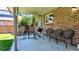 Relaxing covered patio is furnished with chairs and a grill for outdoor gatherings and comfortable relaxation at 16639 E Berry Ln, Centennial, CO 80015