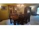 Elegant dining room with a wooden table, chairs, chandelier, and custom china cabinet at 16639 E Berry Ln, Centennial, CO 80015
