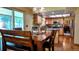 Kitchen featuring wood cabinets, stone counters, stainless appliances, and dining table near sliding glass doors at 16639 E Berry Ln, Centennial, CO 80015