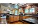 Well-lit kitchen features wooden cabinets, black counters and stainless steel appliances at 16639 E Berry Ln, Centennial, CO 80015