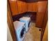 Well-lit laundry room with wooden cabinets above washer and dryer and sink basin at 16639 E Berry Ln, Centennial, CO 80015