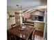 Open-concept living room with a brick fireplace, wooden accents, and a comfortable seating area at 16639 E Berry Ln, Centennial, CO 80015