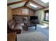 Inviting living room with exposed beams, brick fireplace, and a comfortable seating area at 16639 E Berry Ln, Centennial, CO 80015