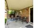 Relaxing covered patio featuring comfortable seating, brick exterior, and view of the well-manicured backyard, great for outdoor gatherings at 16639 E Berry Ln, Centennial, CO 80015