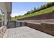 Back deck area with a gray privacy fence with an open view of the hillside at 6835 Surrey Trl, Littleton, CO 80125