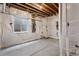 Bright unfinished basement featuring insulated walls, unfinished concrete floor, and a window for natural light at 6835 Surrey Trl, Littleton, CO 80125