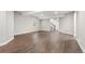 Open basement area with hardwood floors, ample lighting, and staircase to upper level at 6835 Surrey Trl, Littleton, CO 80125