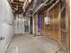 Unfinished basement with exposed beams, plumbing, HVAC, and concrete floor ready for customization at 6835 Surrey Trl, Littleton, CO 80125