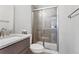Updated bathroom features a vanity with a new countertop and glass-enclosed shower at 6835 Surrey Trl, Littleton, CO 80125