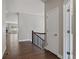 Hallway featuring hardwood floors with views of fireplace, and open doorway at 6835 Surrey Trl, Littleton, CO 80125