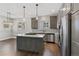 The kitchen features stainless steel appliances, countertops, and pendant lighting at 6835 Surrey Trl, Littleton, CO 80125