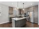 The kitchen features stainless steel appliances, countertops, and pendant lighting at 6835 Surrey Trl, Littleton, CO 80125