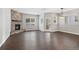Bright living room featuring hardwood floors, a stone fireplace, and large windows for plenty of natural light at 6835 Surrey Trl, Littleton, CO 80125