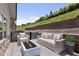Outdoor patio with comfortable seating, a modern fire pit, and lush green surroundings at 6835 Surrey Trl, Littleton, CO 80125