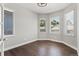Bright room with hardwood floors and plenty of natural light from three large windows at 6835 Surrey Trl, Littleton, CO 80125