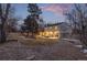Expansive backyard with manicured lawn, mature trees, and inviting patio perfect for outdoor living at 11861 E Yale Ct, Aurora, CO 80014